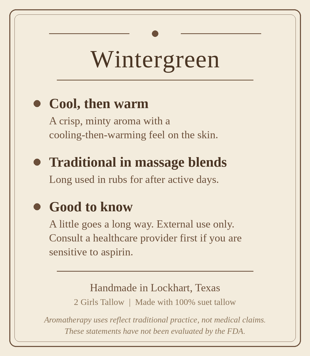 Beige card titled "Wintergreen" listing three points: cool, then warm (a crisp, minty aroma with a cooling-then-warming feel on the skin), traditional in massage blends (long used in rubs for after active days), and good to know (a little goes a long way, external use only, consult a healthcare provider first if you are sensitive to aspirin). Footer reads "Handmade in Lockhart, Texas. 2 Girls Tallow | Made with 100% suet tallow," followed by a note that aromatherapy uses reflect traditional practice, not me